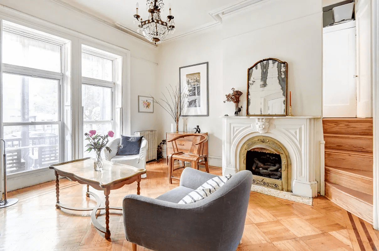 view of parlor with moldings, mantel and window shutters