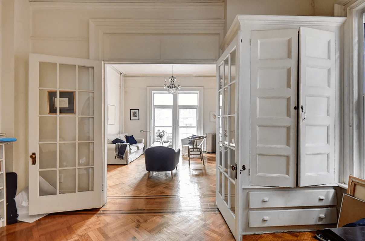 view into parlor showing french doors and a built-in storage