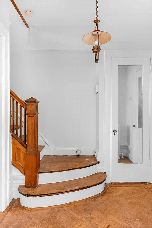 entry with original stair and a glass doored closet
