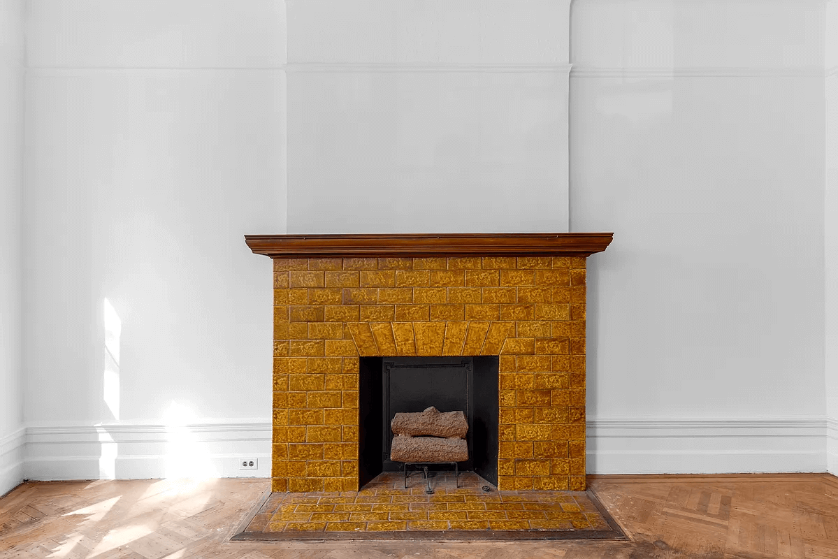 wood mantel with golden tile hearth and surround