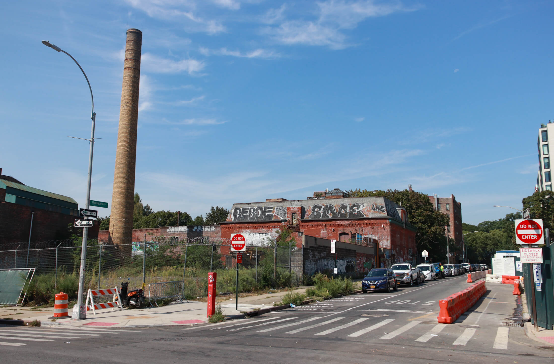 view on montgomery street showing the smokestack and a mansard roofed factory building