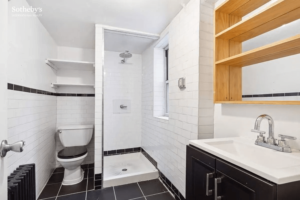 bathroom with black floor tile