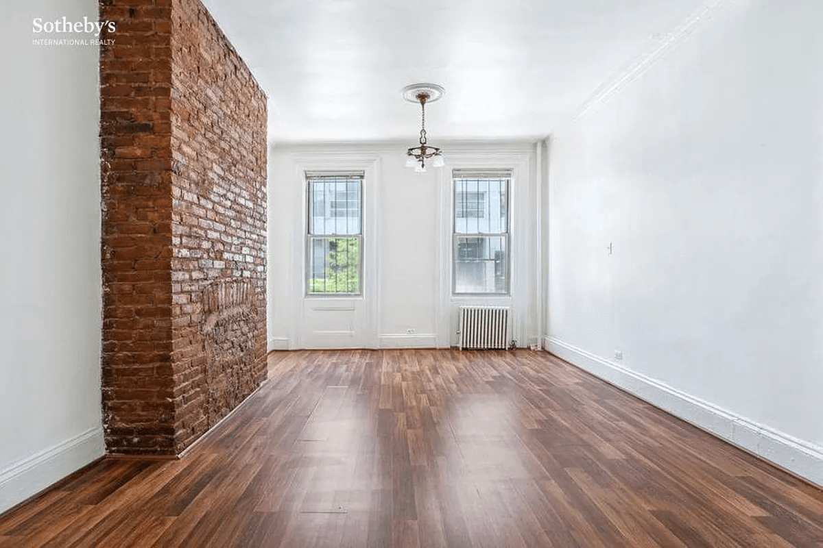 living room with brick chimney wall