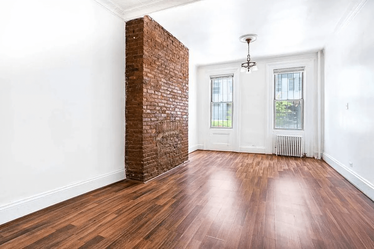 living room with brick chimney wall