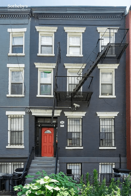 blue painted exterior with a red door