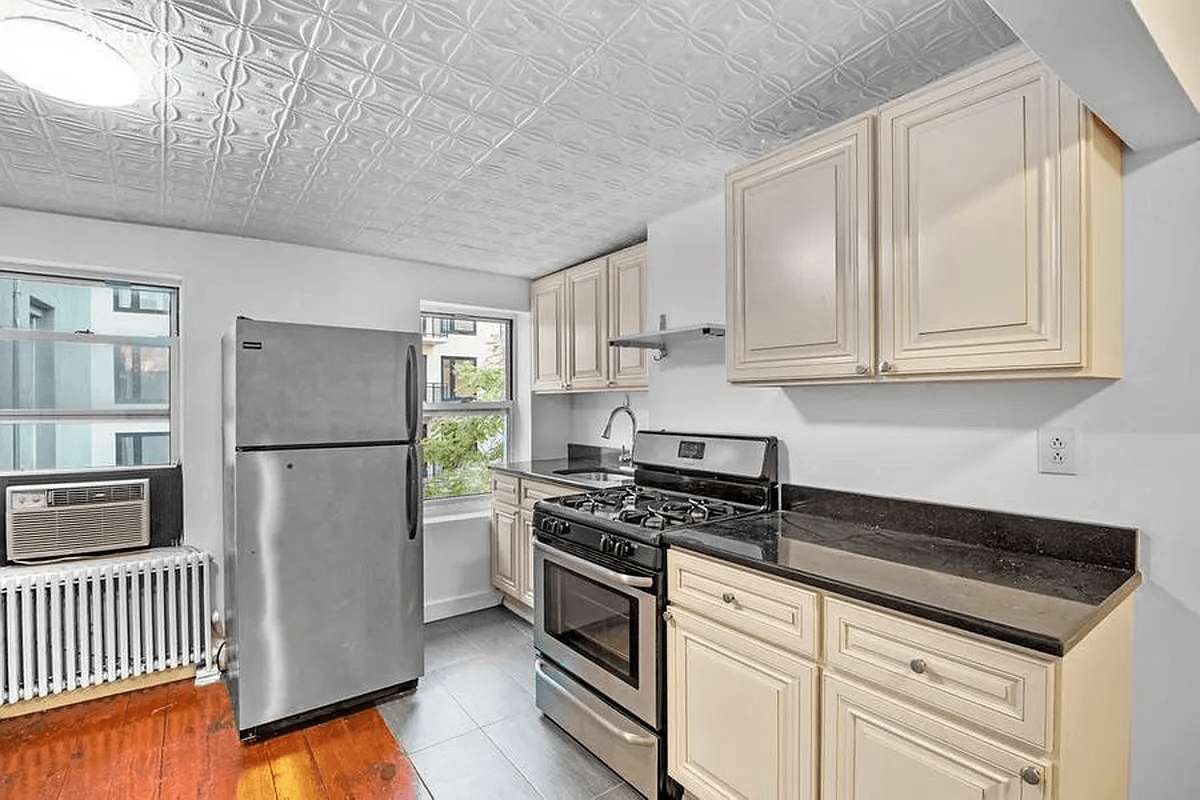 kitchen with tin ceiling and wood and tile floor