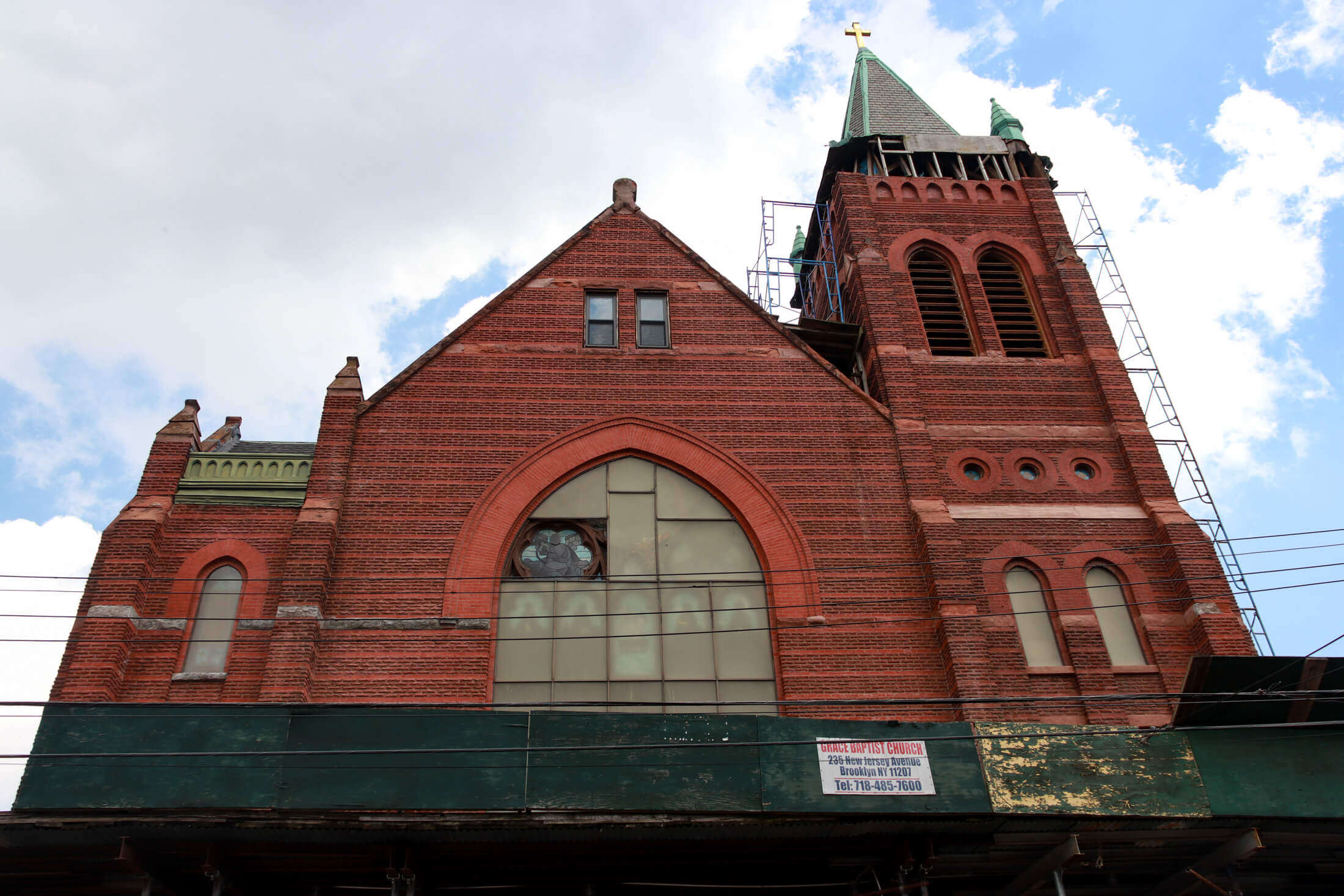 church exterior with sidewalk shed and scaffolding