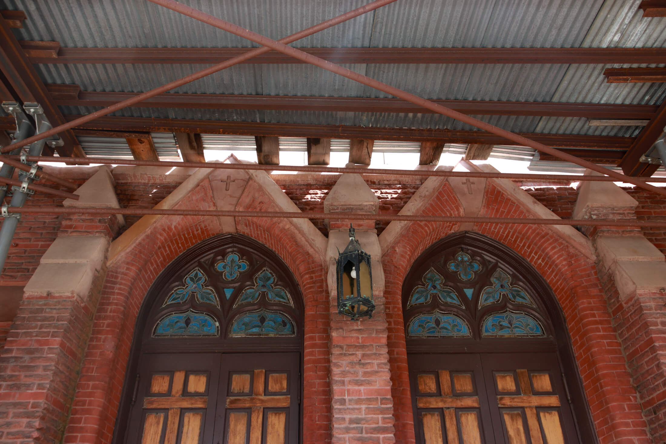 front doors of church with stained glass windows