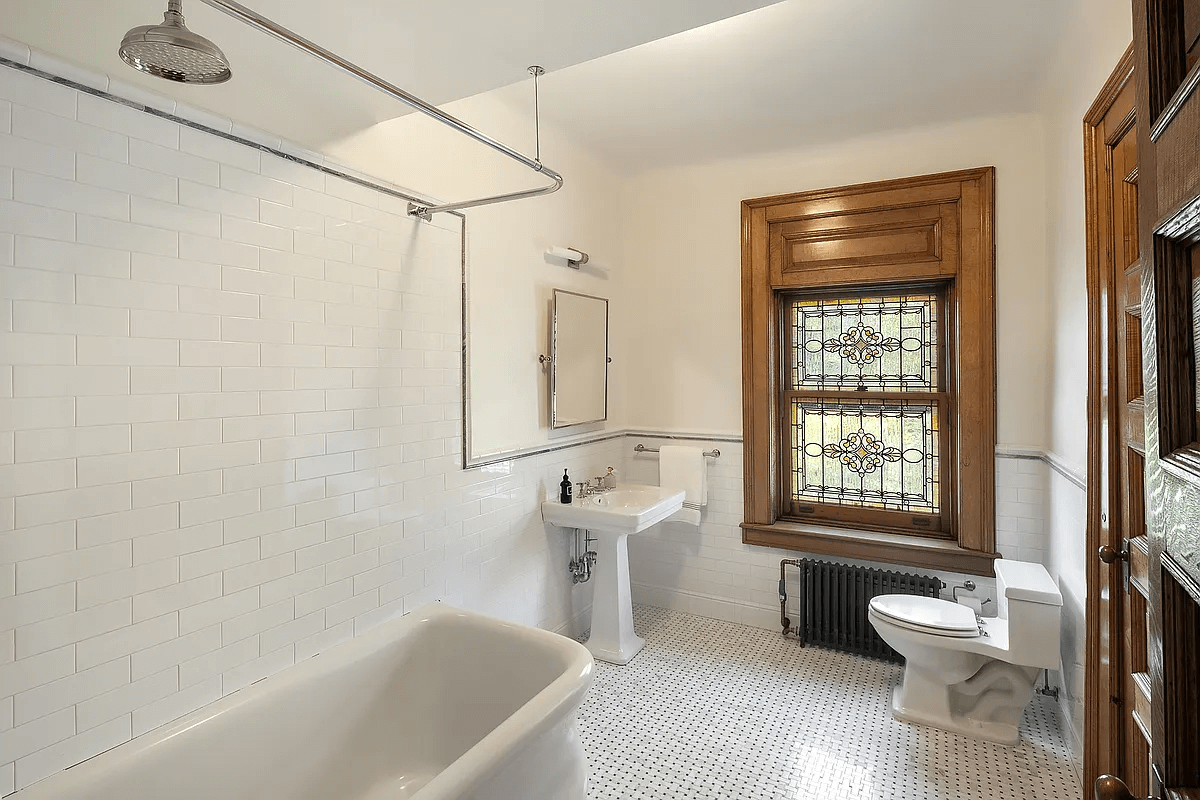 bathroom with tub and stained glass window