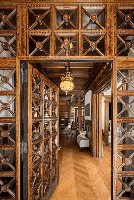 entry with ornamental wood doors from vestibule