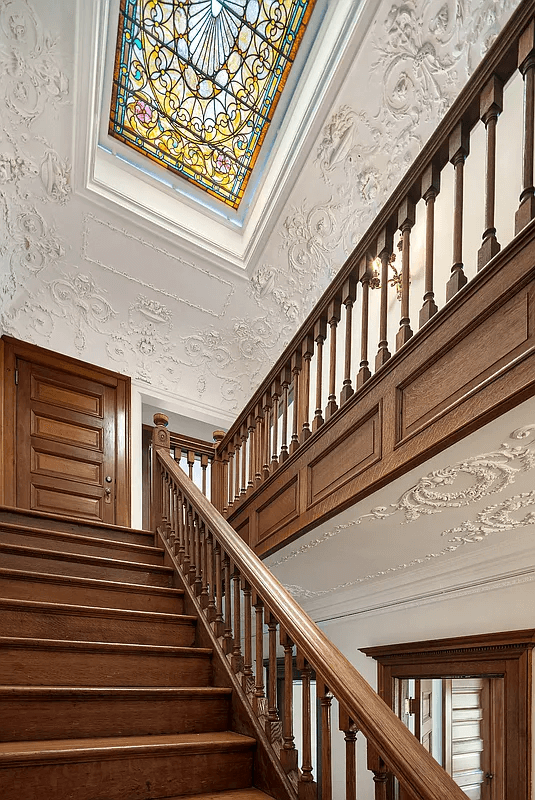 staircase with view of stained glass skylight