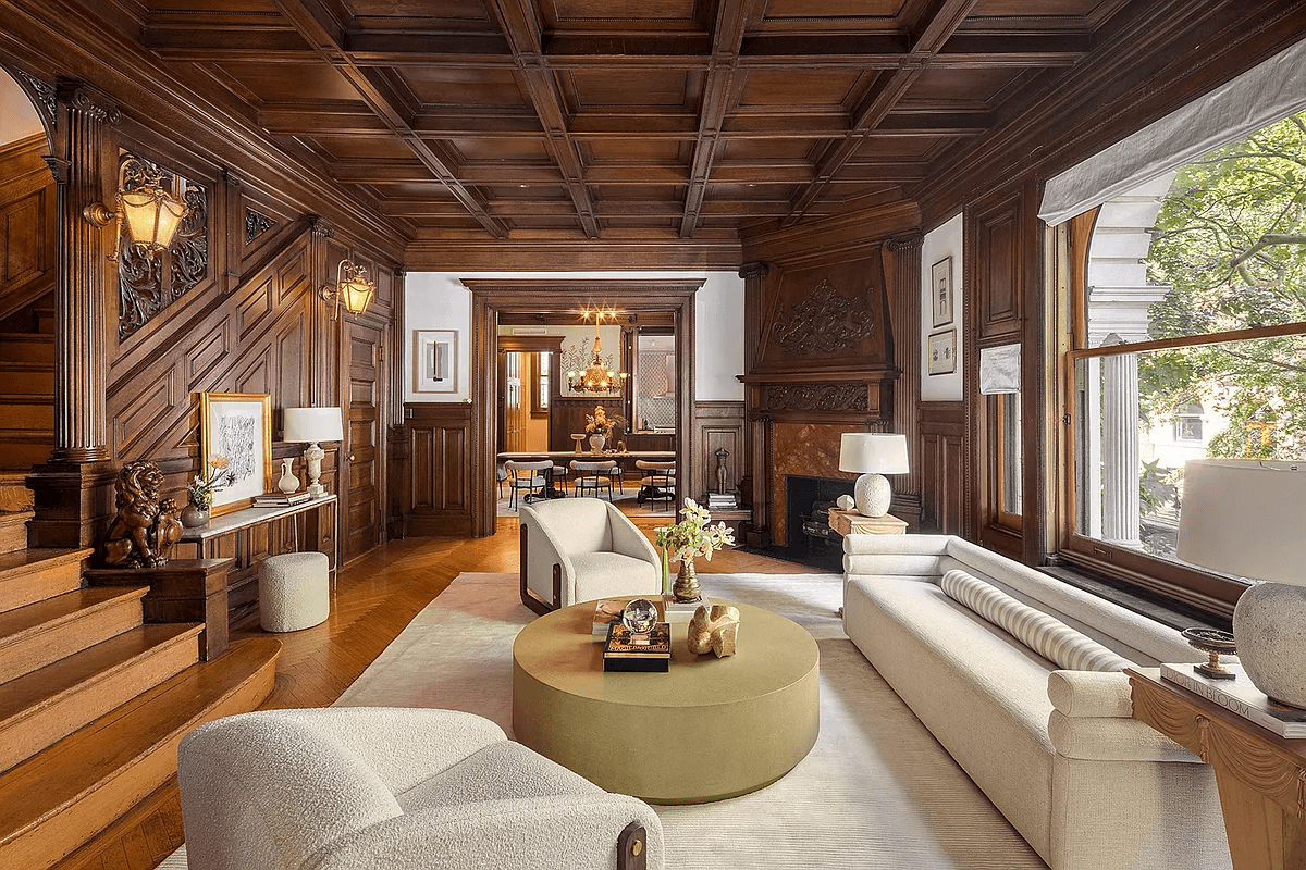 wood filled middle parlor with wainscoting, coffered ceiling, original stair and corner mantel