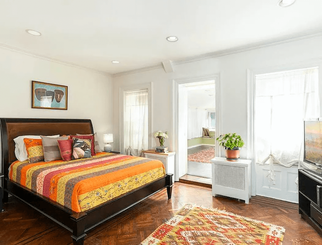 bedroom with view into the adjoining sleeping porch