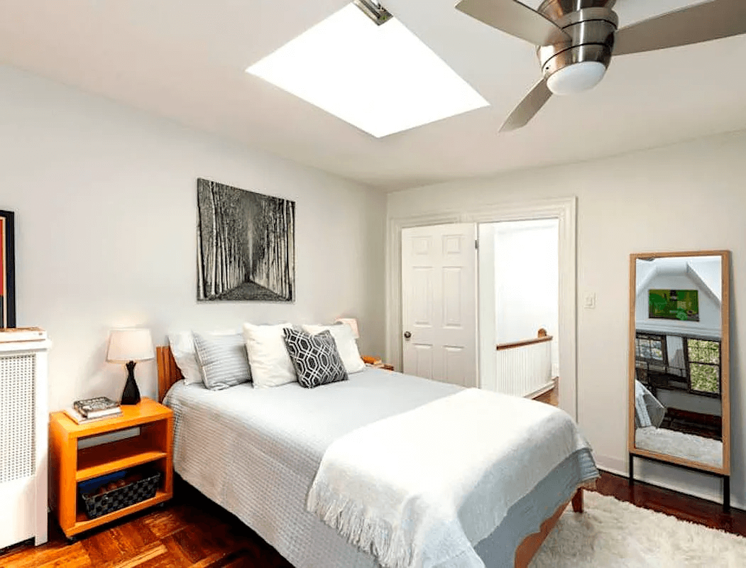 bedroom with a skylight and a ceiling fan