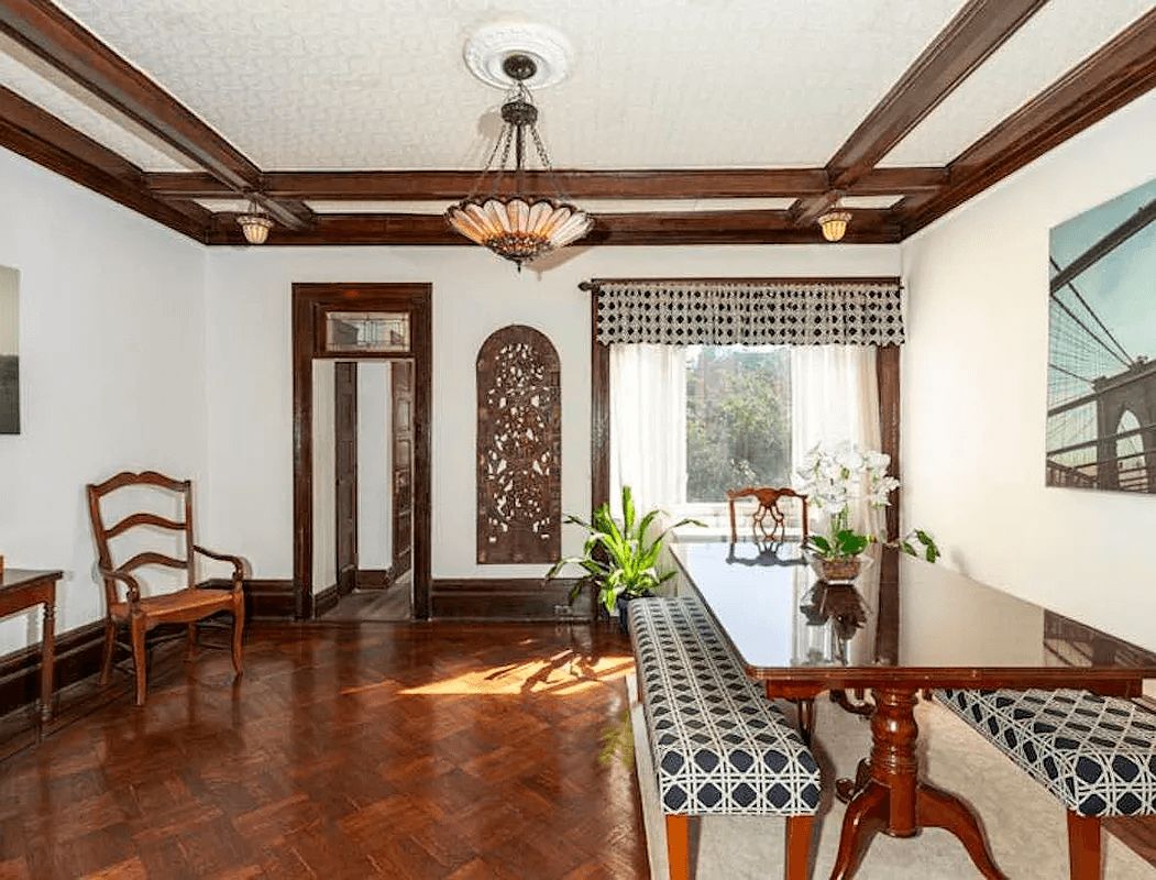 dining room with coffered ceiling and wood floors