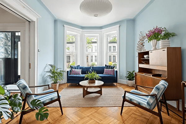 brooklyn open houses - a parlor with wood floors and a bay window