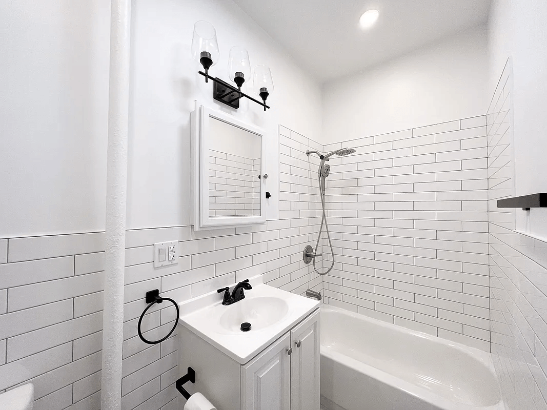 bathroom with white subway tile and white fixtures