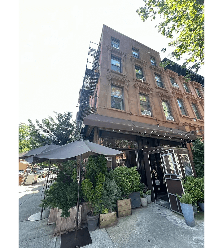 brownstone exterior with a restaurant on ground floor