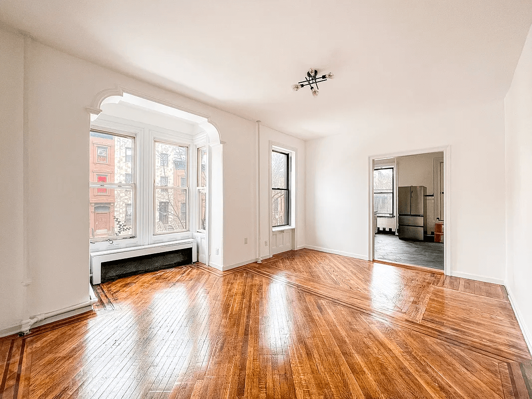 living room with wood floors, oriel window