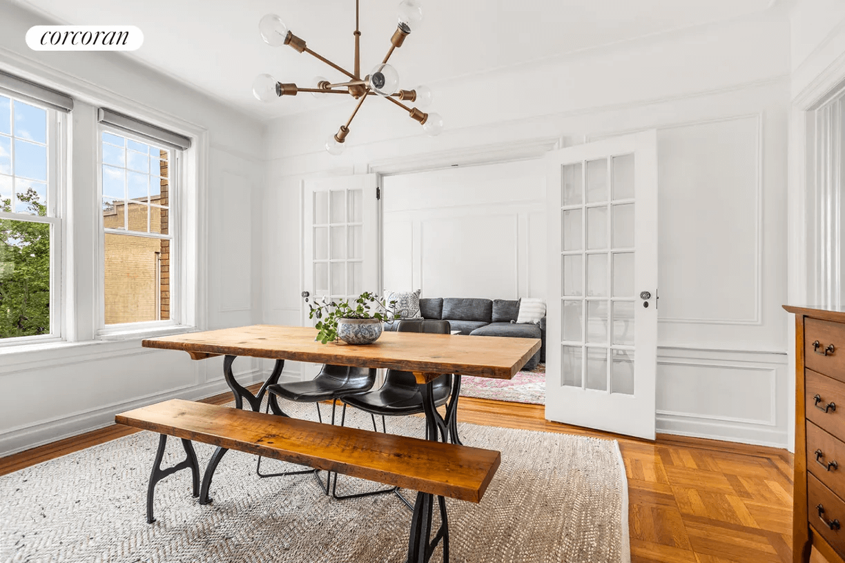 dining room with chandelier, wall moldings and picture rails