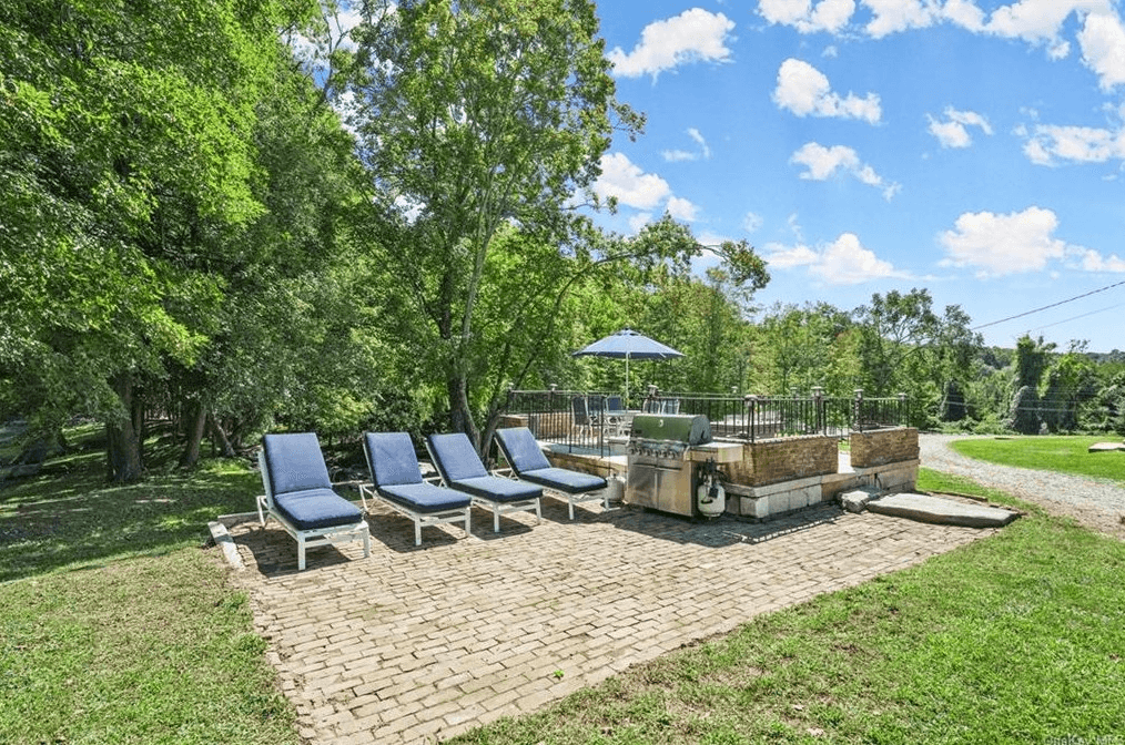 raised and fenced pool with brick patio