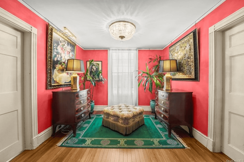 hall with wood floors and red walls