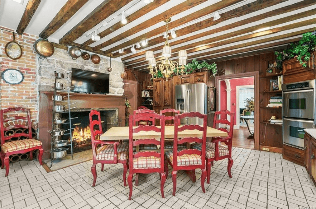 kitchen with beamed ceiling, white tile floor and mantel