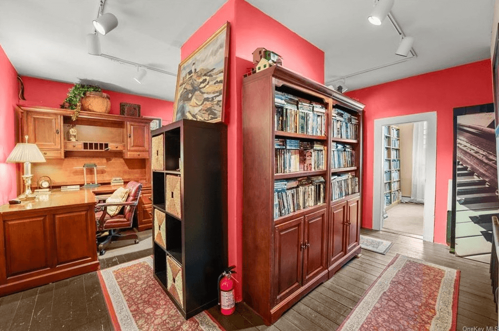 office space with wood floors and red walls