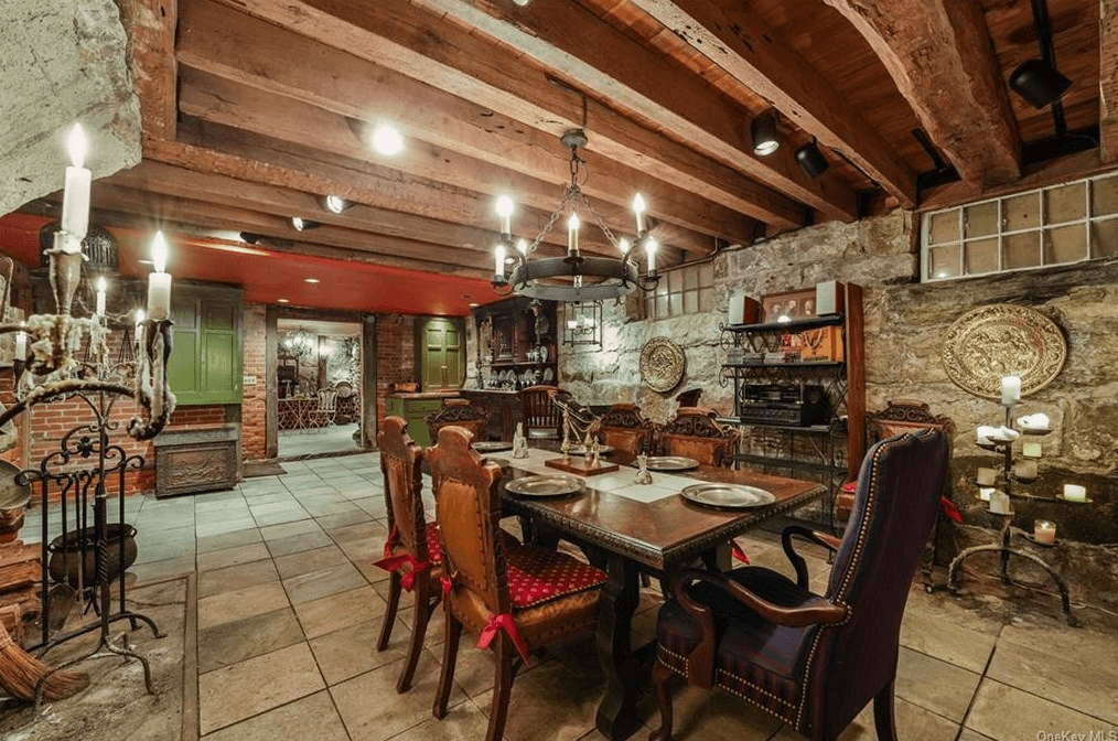 basement dining area with tile floor and beamed ceiling