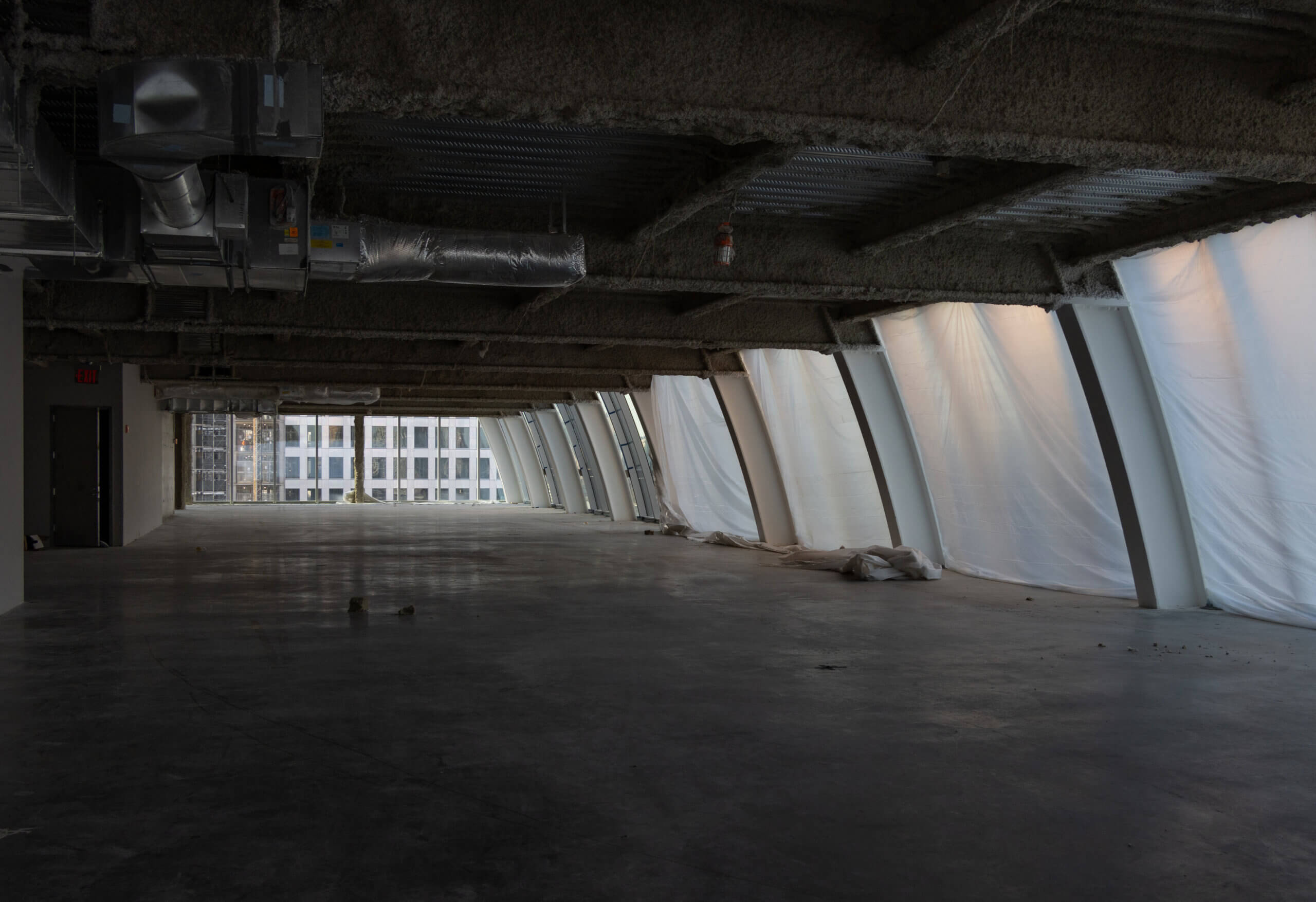 windows still covered with plastic sheeting on the 14th floor