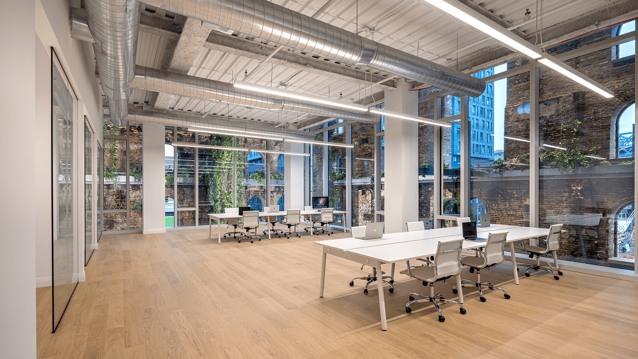 office with wood floors and exposed ductwork