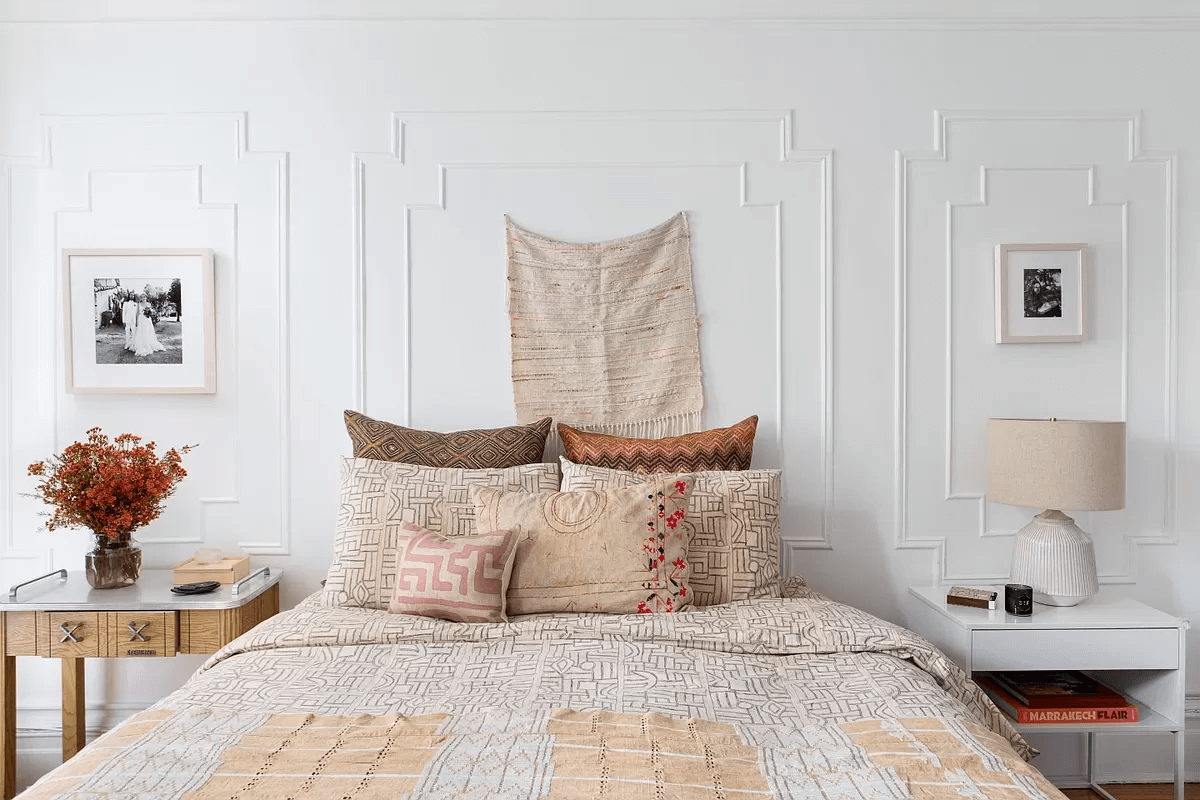 bedroom with white walls with wall moldings