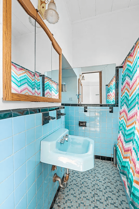 bathroom with vintage blue wall tile with a blue sink