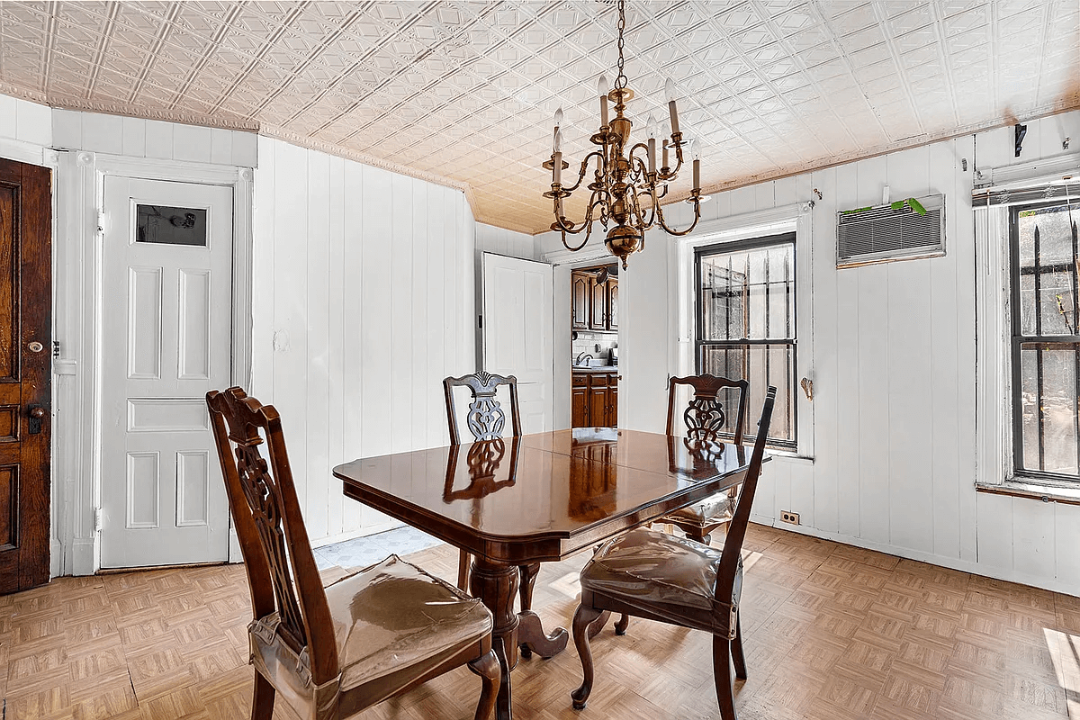 rear dining room on garden level with tin ceiling and white wall paneling