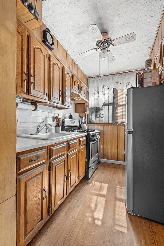 garden level kitchen with paneling and wood cabinets