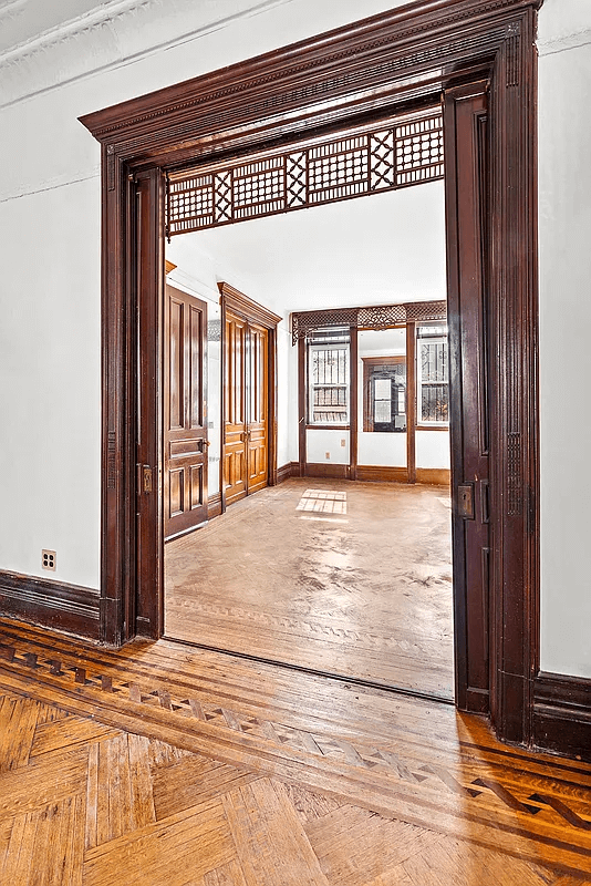 view through front parlor doorway with fretwork screen