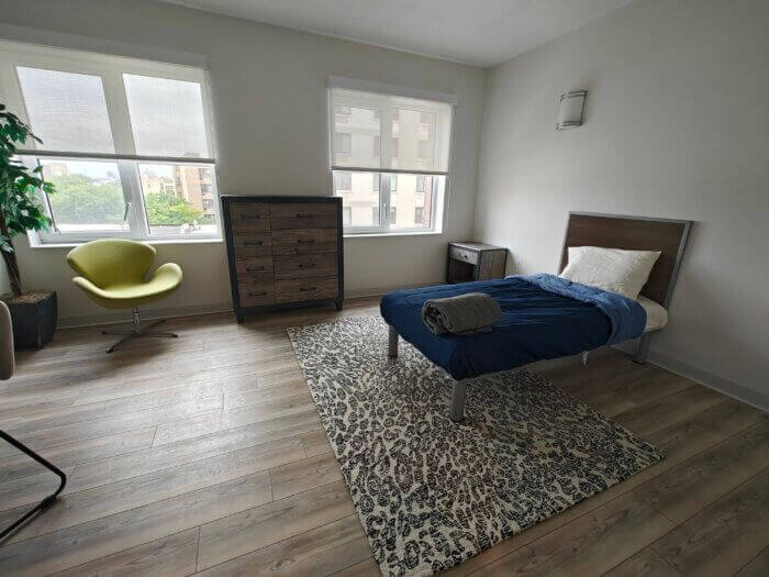 bedroom with white walls and two windows