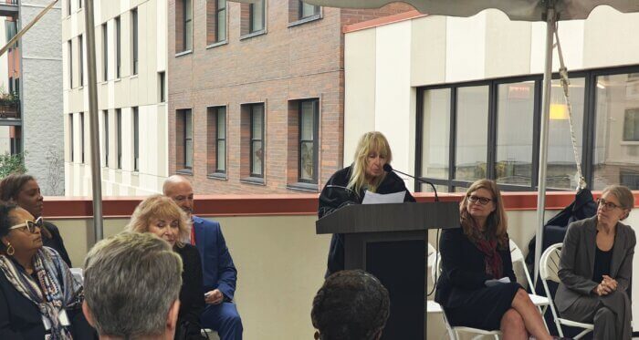 resident speaking in front of a podium