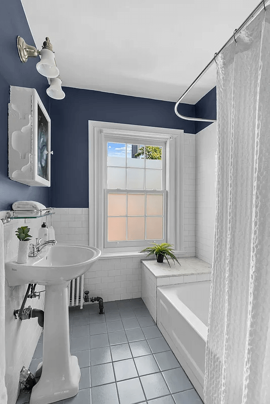 bathroom with white fixtures and grey blue floor tile