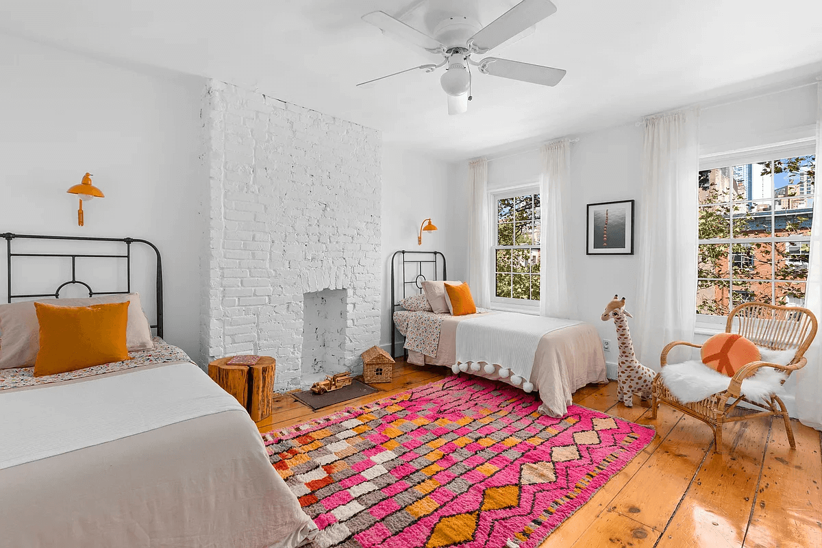 top floor bedroom with brick chimney wall painted white