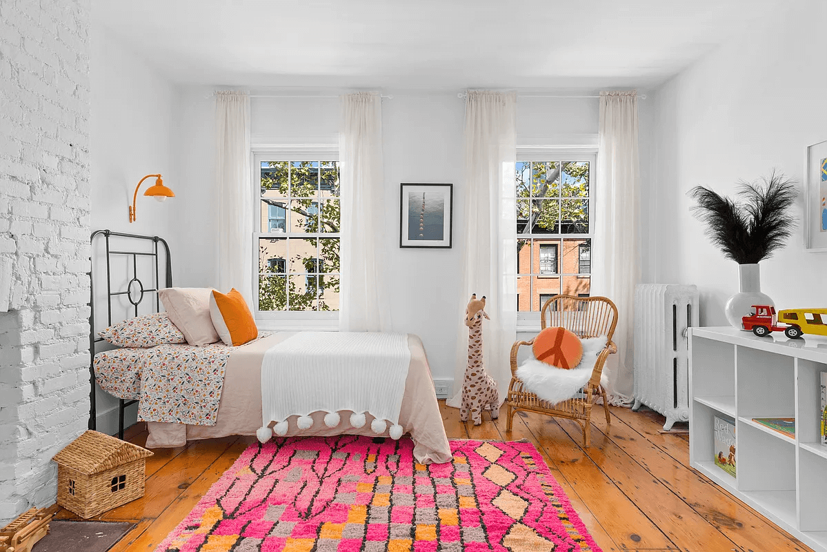 top floor bedroom with brick chimney wall painted white