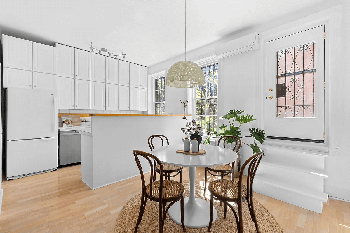 kitchen with white cabinets and peninsula between it and dining area
