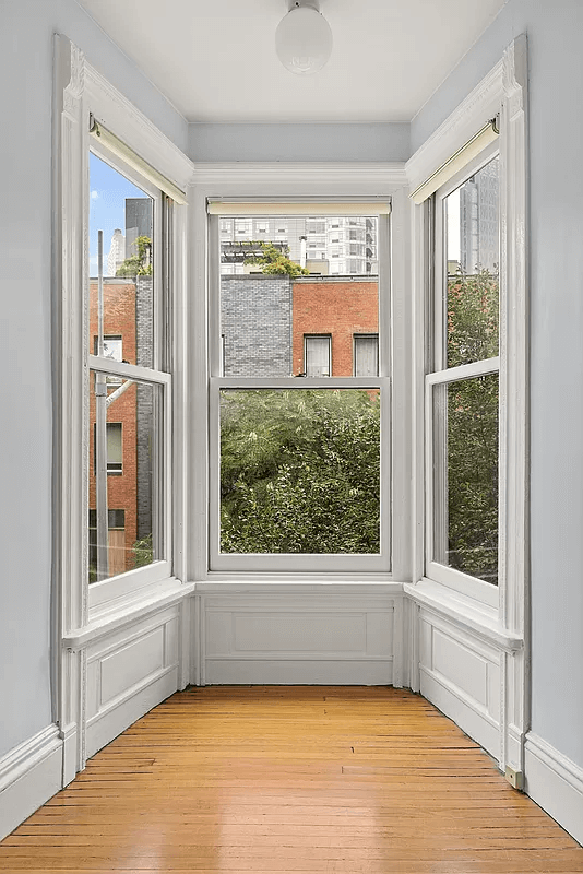 small bedroom with bay window looking