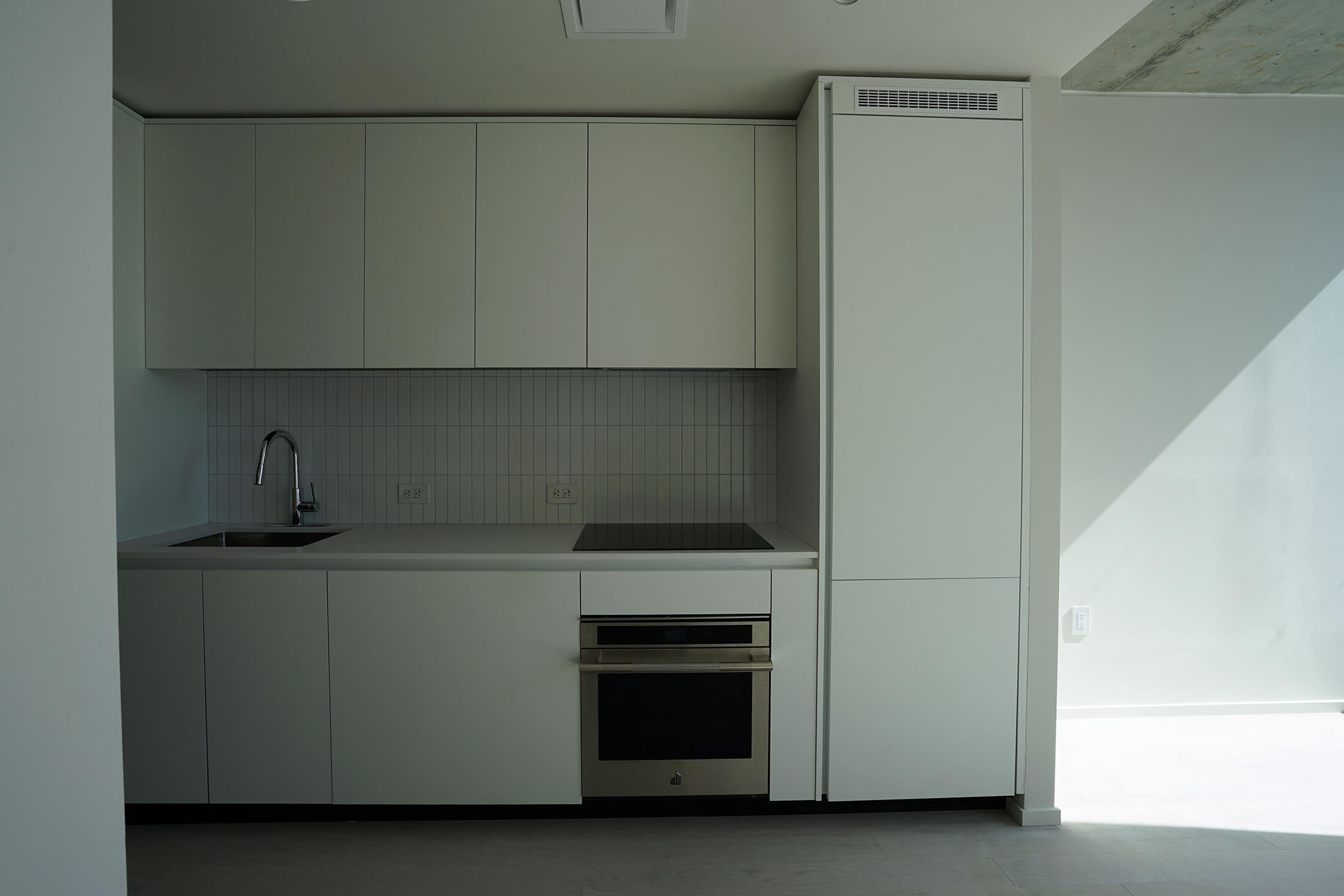 a kitchen with white cabinets