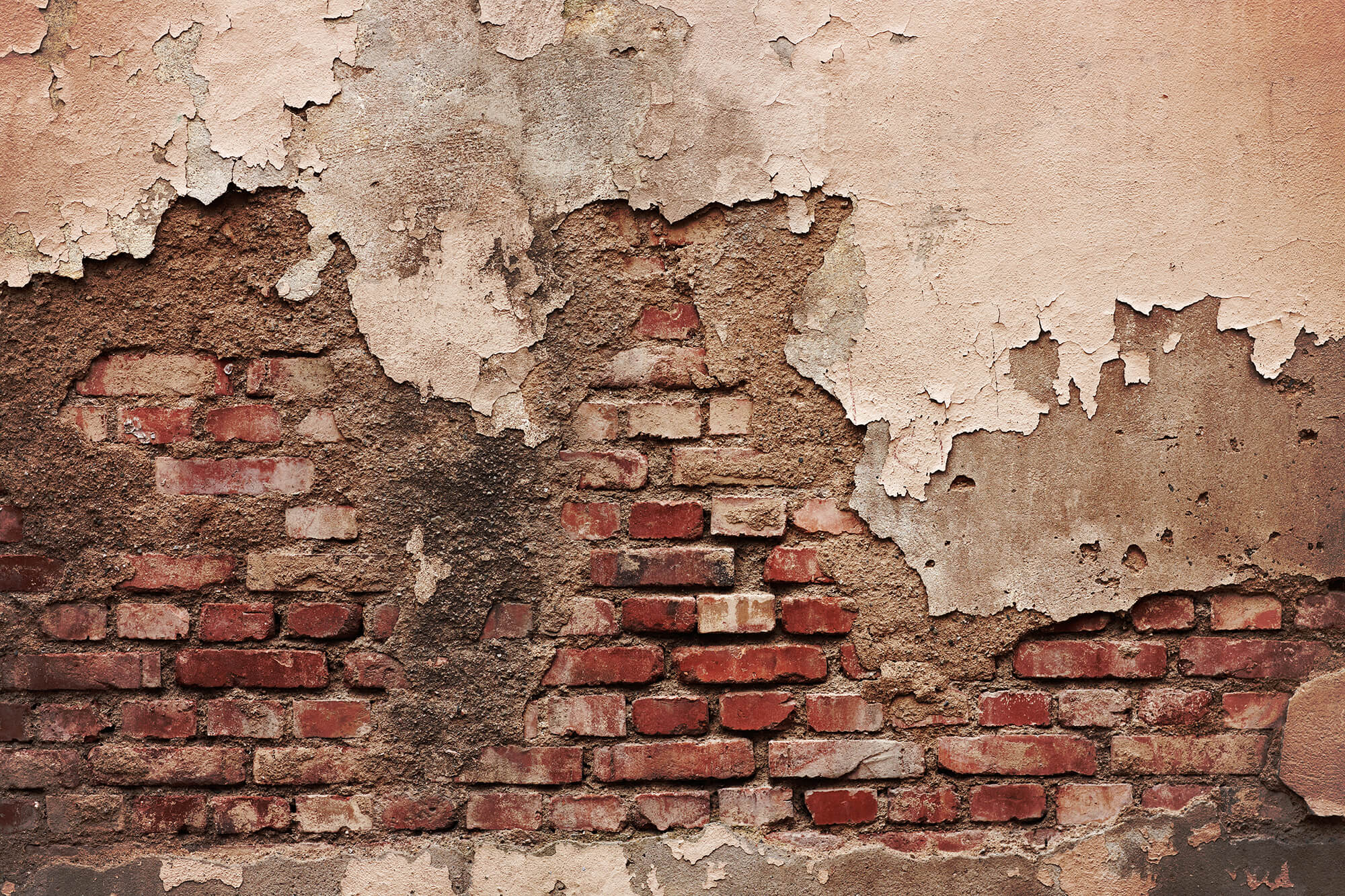 brick wall - grungy with stucco, crumbling bricks