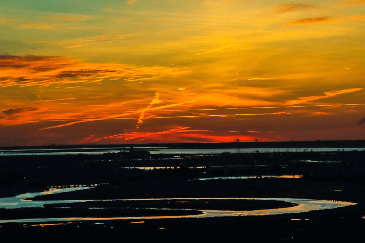 artwork- a landscape with water and a colorful sky