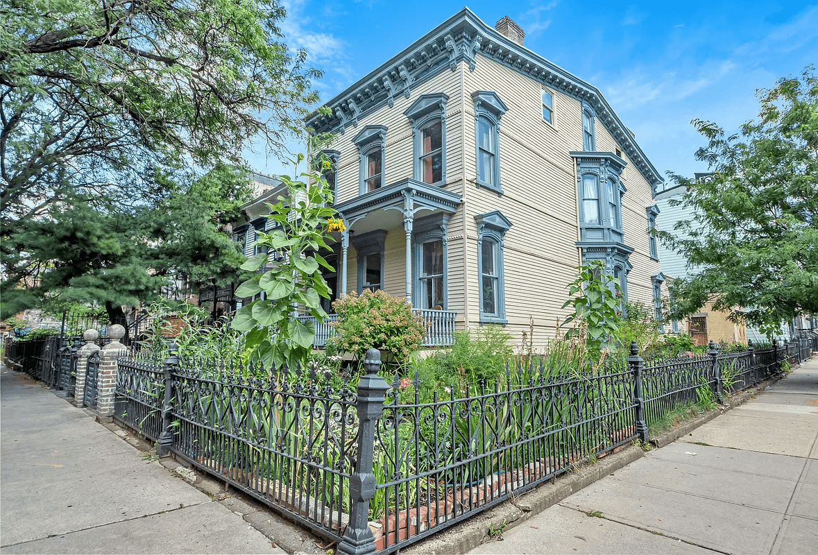 bushwick - wood frame yellow clapboard house with blue trim