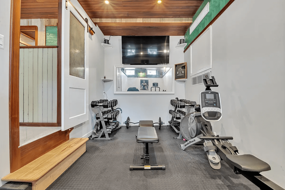 narrow gym on garden level with rubber floor and wood slat ceiling