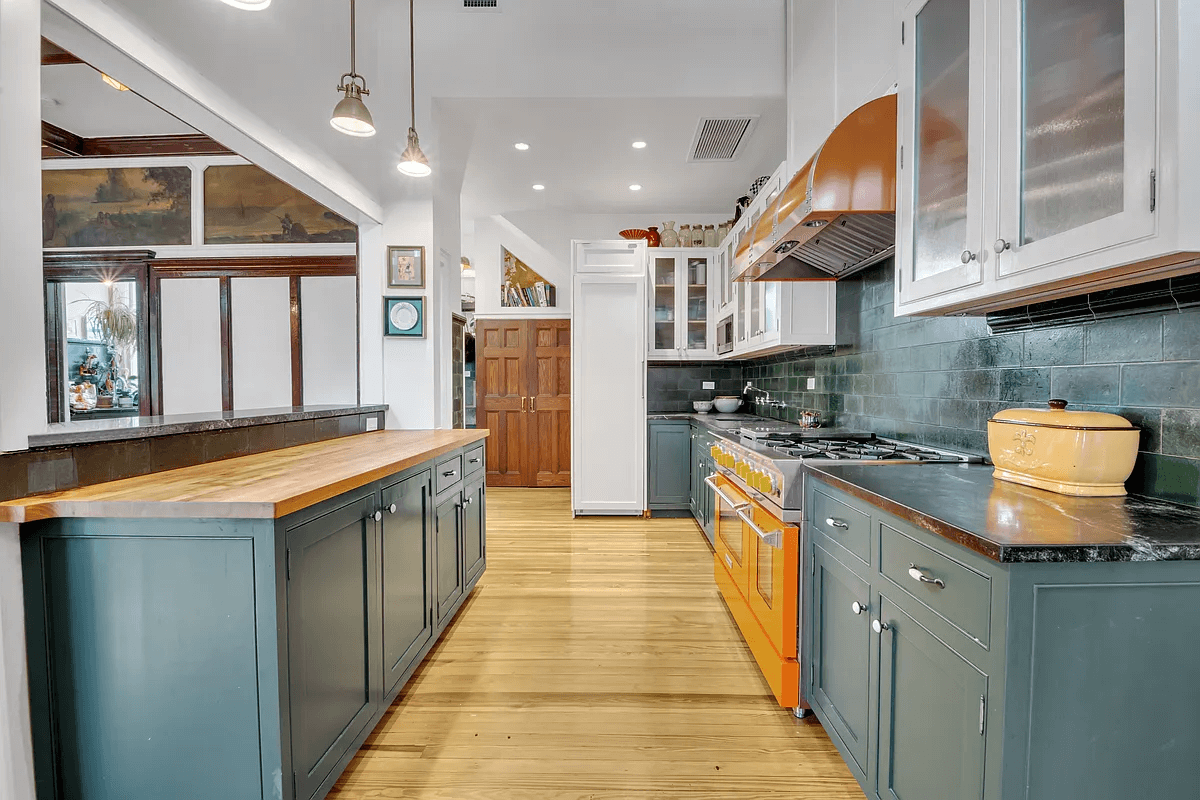 kitchen with green cabinets and passthrough to the dining room