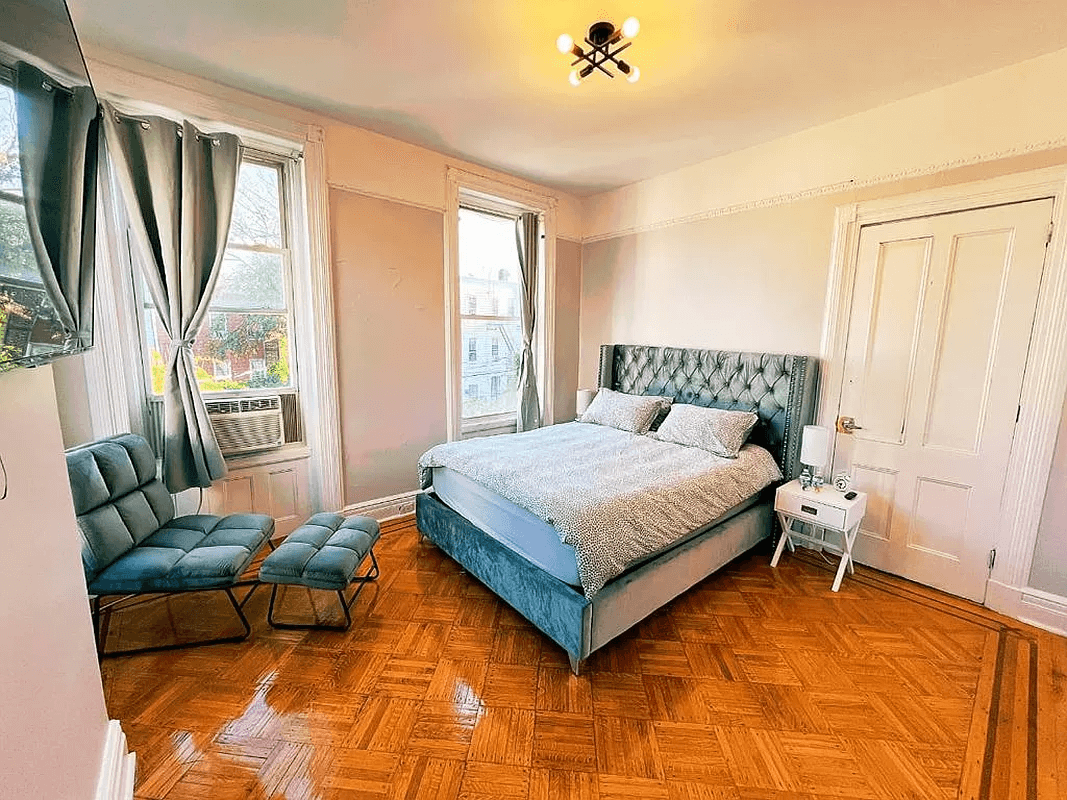 bedroom with wood floor and picture rail